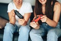 Girls holding gamepads and playing video games Royalty Free Stock Photo