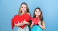 Girls hug red plush heart toy symbol love. Sisterhood concept. Valentines day. Friendly relations siblings. Family love