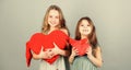 Girls hug red plush heart toy symbol love. Sisterhood concept. Valentines day. Friendly relations siblings. Family love Royalty Free Stock Photo