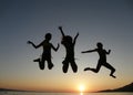 Girls jumping in sunset Royalty Free Stock Photo