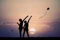 Girls with kite at sunset