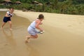 Girls laughing and playing on beach Royalty Free Stock Photo