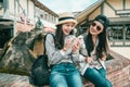 Girls laughing while sitting to the fountain