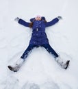 Girls laying in star shape in snow Royalty Free Stock Photo