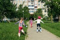 Girls learn to skate on the street. Children wear protective pads and a protective helmet for safe riding on rollers. Active Royalty Free Stock Photo