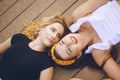 The girls are on the pier near the beach. Girls smile, sunbathe. Summer vacations, girlfriends, traveling, vacations with friends Royalty Free Stock Photo