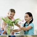 Girls looking at flowers Royalty Free Stock Photo