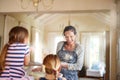 The girls love their baking. Shot of two little girls having fun while baking with their mother in the kitchen. Royalty Free Stock Photo