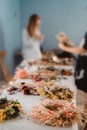 Girls making floral door wreath from colorful dry summer flowers and plants. Royalty Free Stock Photo