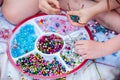 Girls making snowflakes and flowers with the box of various beads and pipe cleaners