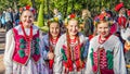 The girls members of the Polish folk dance GAIK walking in the park.