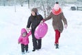 girls and mother go forward in the snow holding hands Royalty Free Stock Photo