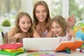 Girls with mother on lesson with laptop Royalty Free Stock Photo