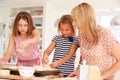 Girls With Mother Making Cheese On Toast