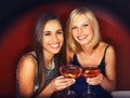 Girls only night out. Two gorgeous young woman enjoying cocktails. Royalty Free Stock Photo