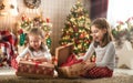 Girls opening Christmas gifts