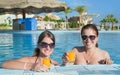 Girls with orange juice at resort hotel