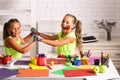 Girls painters painting with gouache paints on table