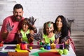 Girls painters painting with mother and father