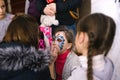 Girls painting faces to children a master class at the opening of a children`s center in Cherkasy, Ukraine, March 23, 2018
