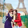 Girls in Paris doing selfie near the Eiffel tower Royalty Free Stock Photo