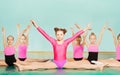 Girls performing splits during gymnastics class