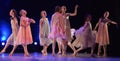 Girls in pink air dresses dancing on stage