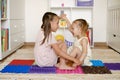 Girls play and have fun together in the children`s room on the floor on orthopedic massage mats