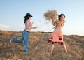 Girls play with hay