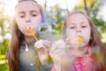Girls play with soap bubbles in a spring time. Royalty Free Stock Photo