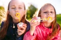 Girls play with soap bubbles in a spring time. Royalty Free Stock Photo