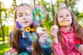 Girls play with soap bubbles in a spring time. Royalty Free Stock Photo