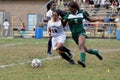 3 girls play in a soccer game