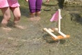 Girls playing with boat in water Royalty Free Stock Photo