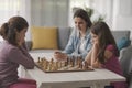 Girls playing chess together at home Royalty Free Stock Photo