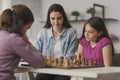 Girls playing chess together at home Royalty Free Stock Photo