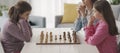 Girls playing chess together at home Royalty Free Stock Photo