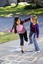 Girls playing hopscotch Royalty Free Stock Photo