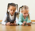 Girls playing online with phones Royalty Free Stock Photo