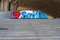 Girls Playing on Seville Sign