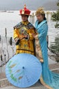 Girls posing in traditional Chinese costumes on the shores of West Lake in Hangzhou, China