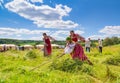 Girls rake up the hay