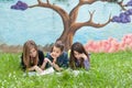 Girls reading a book in the park