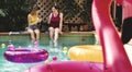 Girls relaxing by the swimming pool