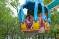 Girls ride a carousel in an amusement park