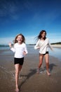 Girls running on beach Royalty Free Stock Photo