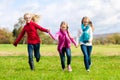 Girls running through fall or autumn park Royalty Free Stock Photo