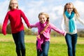 Girls running through fall or autumn park Royalty Free Stock Photo
