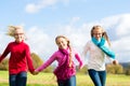 Girls running through fall or autumn park Royalty Free Stock Photo