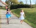 Girls running and riding a bike Royalty Free Stock Photo